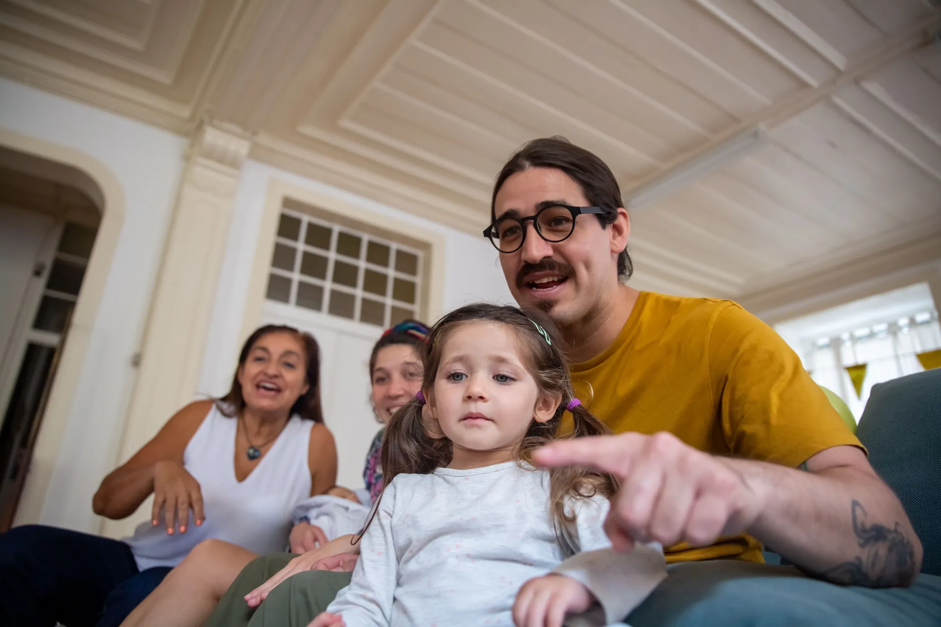A family sharing a relaxed, happy moment together on the porch of their home