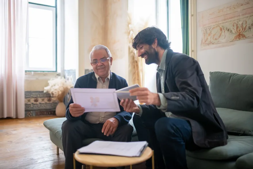 A support coordinator and a client going through documents together at home